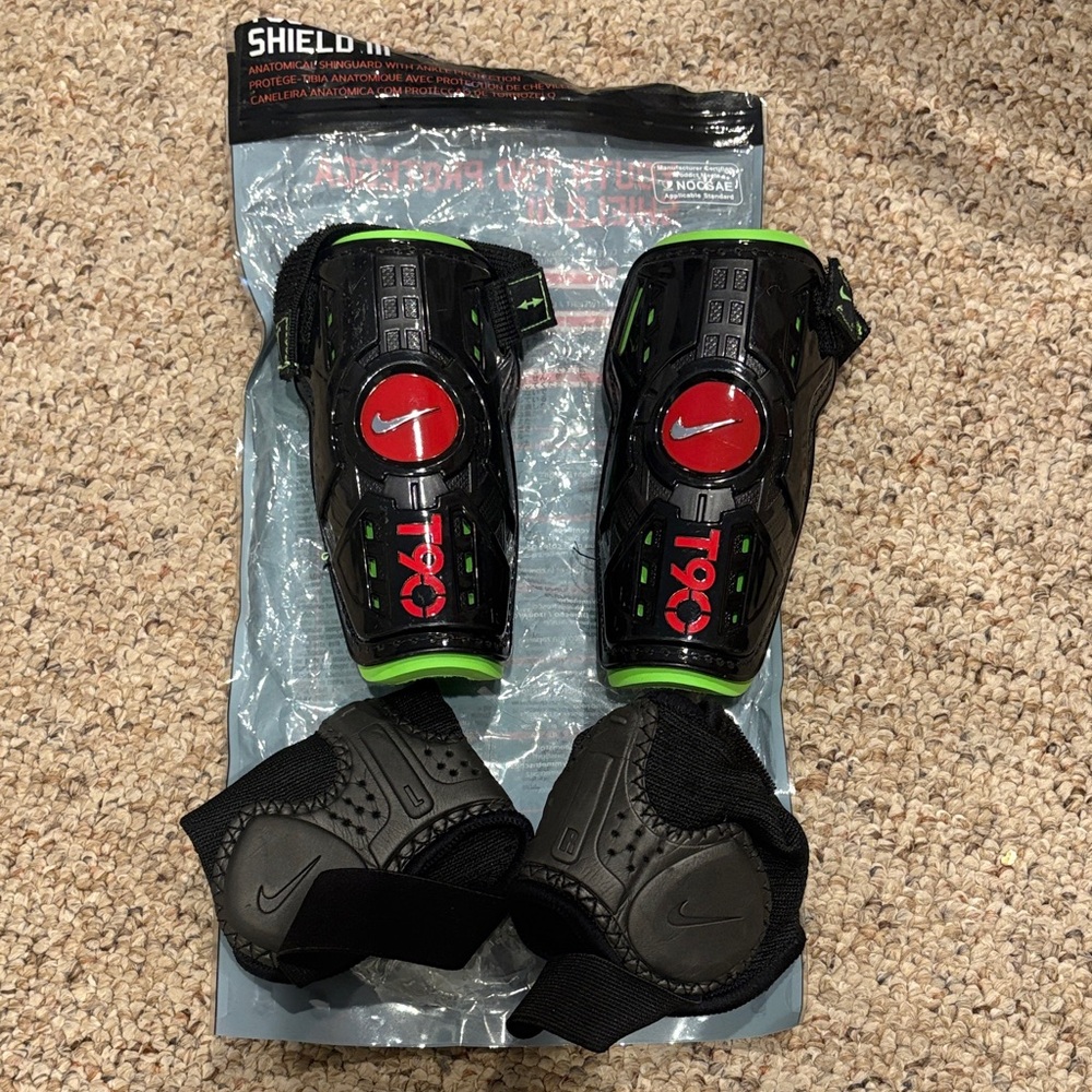 Nike T90 Black and Red Shin Guards with Green Trim